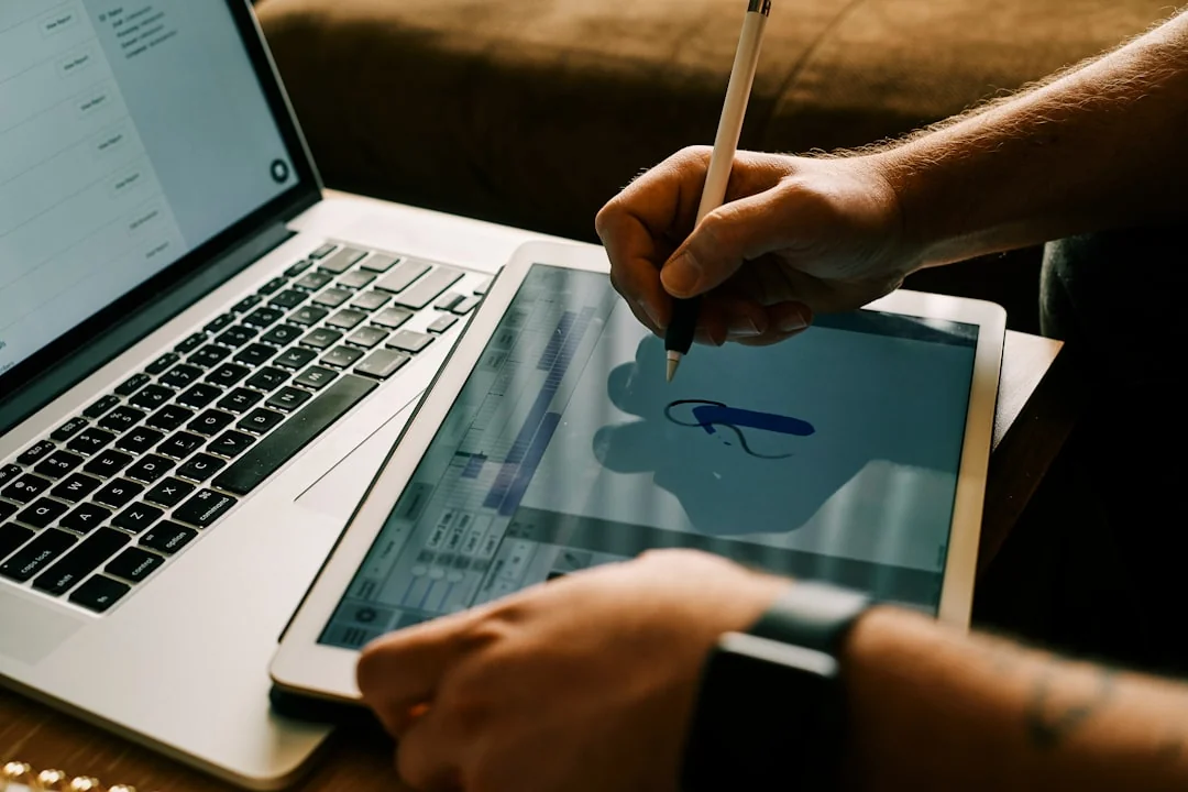 Two businessmen analyze stock market data using a smartphone and laptop in a modern office setting.